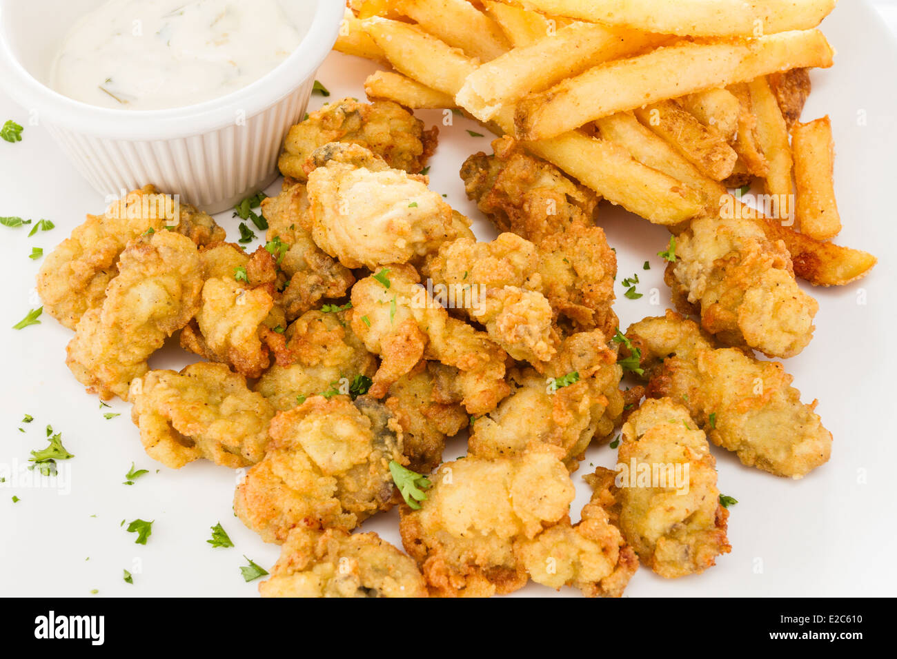 Fried oysters served with French fries and dressing. Stock Photo