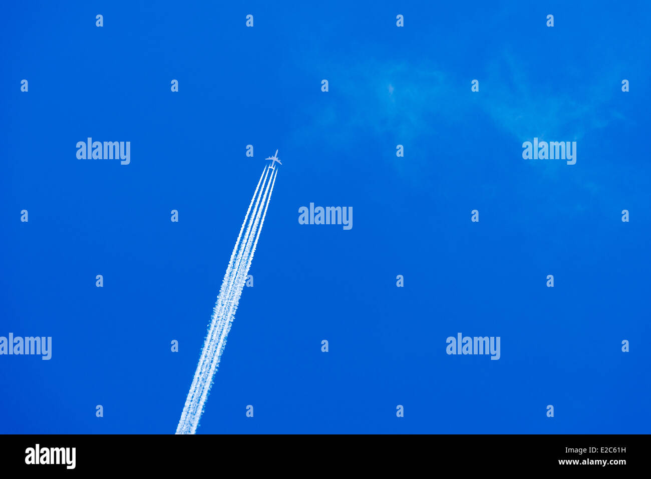 Jet airplane with contrail, also known as a vapor trail. Stock Photo
