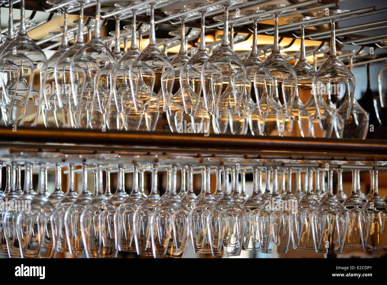 France, Herault, Beziers, wine bar and tapas Le Chameau ivre, set of shelves of stemmed glasses in a ratelier Stock Photo