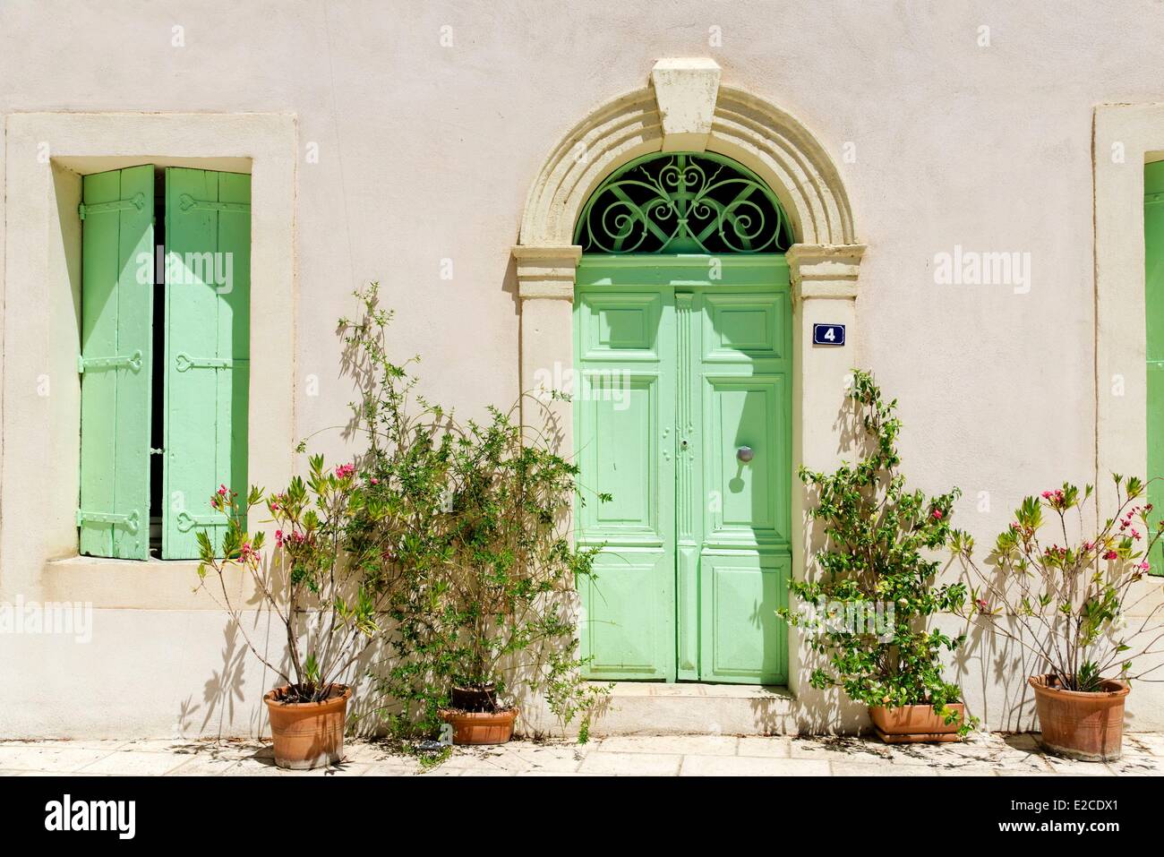 France, Herault, Corneilhan, front door of town Hall with house plants ...