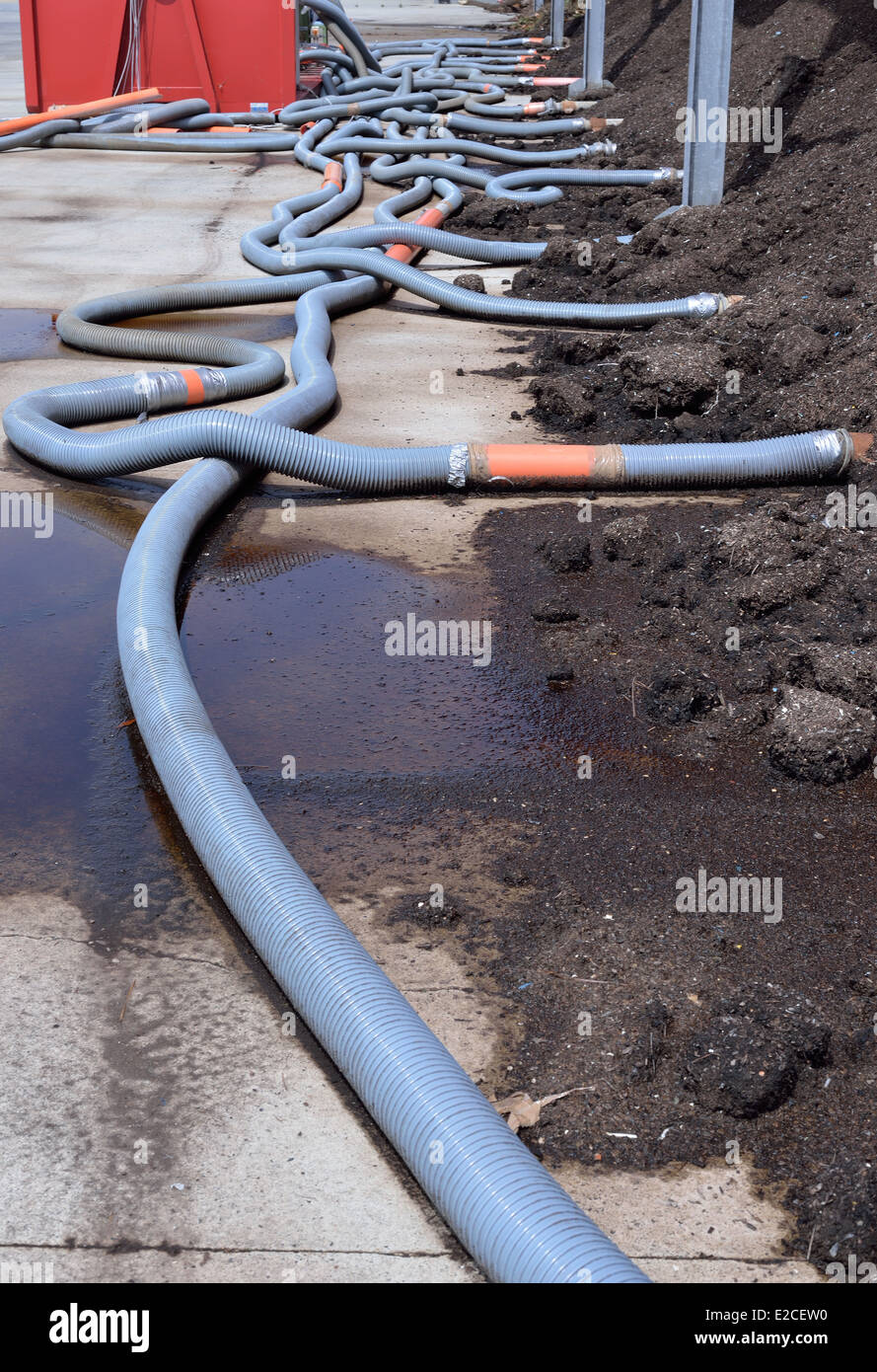 Industrial compost heap with forced aeration pipes and leachate