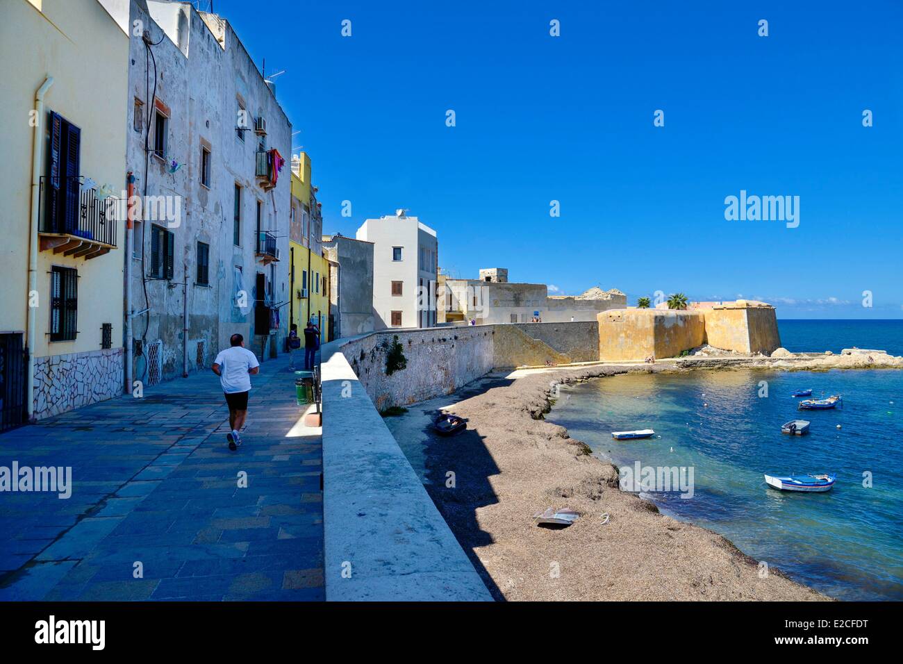 Italy, Sicily, Trapani, historic center, Promenade of Tramontana lined with houses with fortress Conca  in background Stock Photo