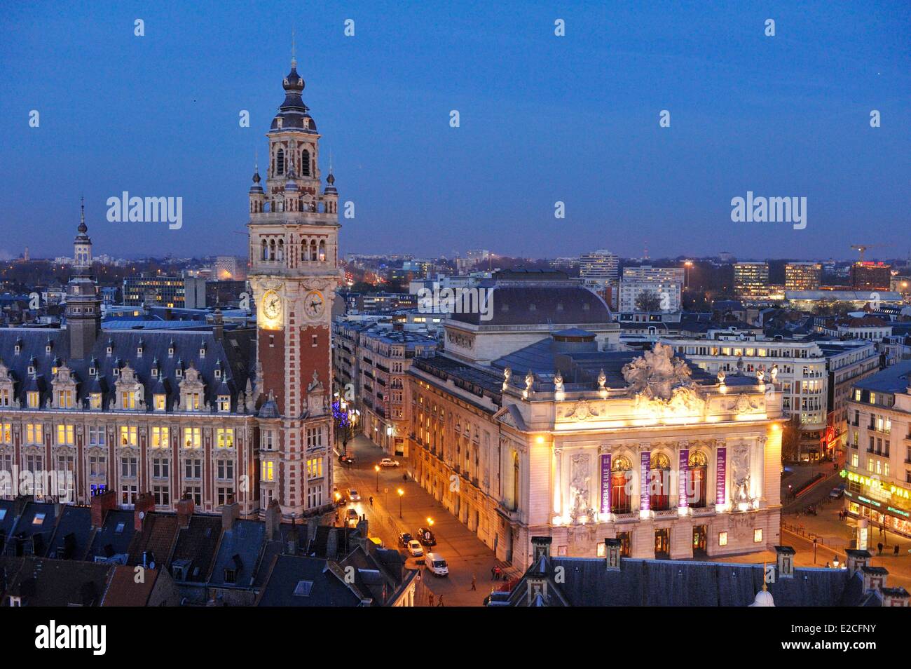 France, Nord, Lille, belfry of Chamber of Commerce and Industry and Opera seen by night from big wheel set up for Christmas Stock Photo