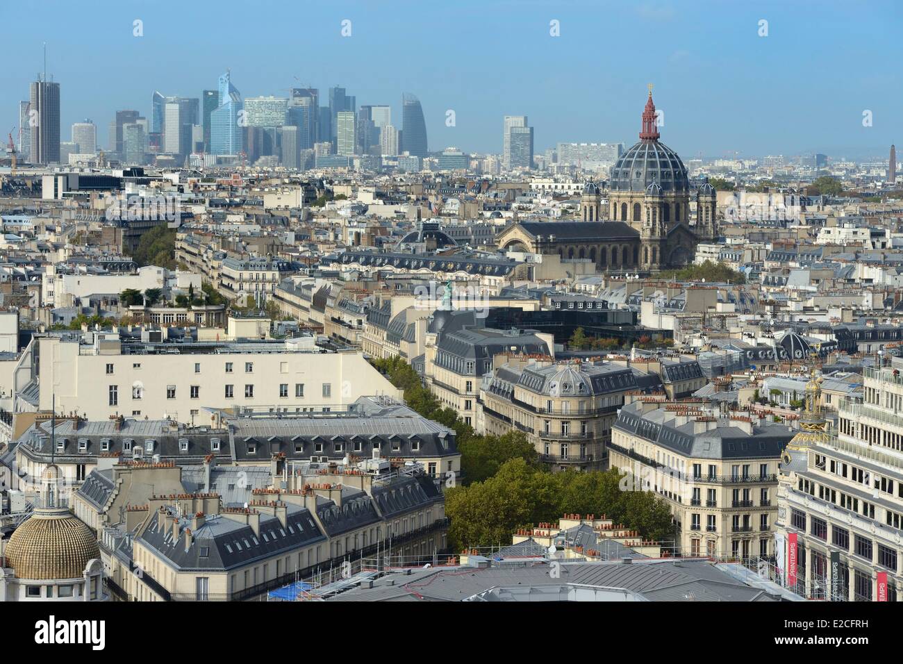 France, Paris, the department store Le Printemps on the boulevard Haussmann, the dome of Saint Augustin Church and the buildings of La Defense District Stock Photo