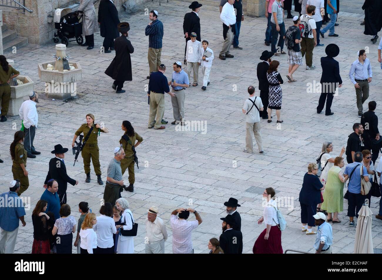 Israel Jerusalem holy city old town World Heritage UNESCO ortodox jews and women soldiers under Temple Mount or Haram Ash Sharif Stock Photo