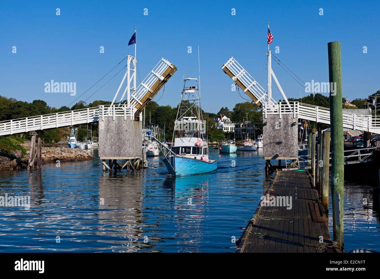 United States Maine Ogunquit Perkins Cove fishing boat passing under the pedestrian drawbridge Stock Photo