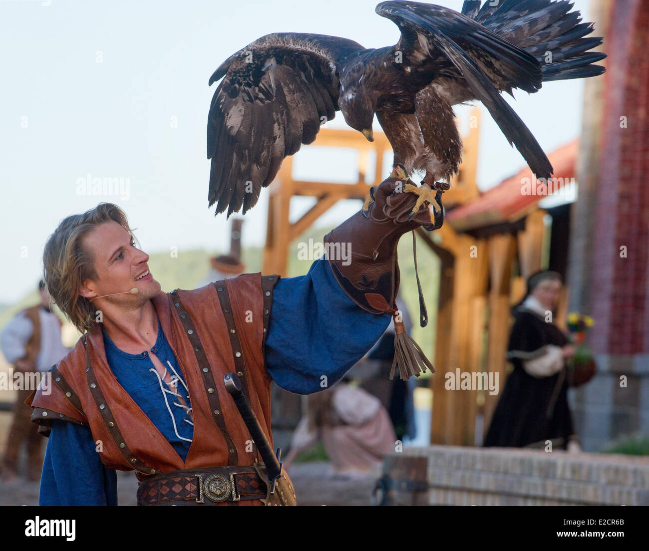 Ruegen, Germany. 18th June, 2014. Actor Bastian Hamm in the role of pirate Klaus Stoertebeker acts with White-tailed eagle Laran during a rehearsal at open-air stage Naturbuehne Ralswiek on Ruegen, Germany, 18 June 2014. The 22nd Stoertebeker Festival starts on 21 June 2014 with the piece 'God's Friend'. The festival counted 340,000 visitors the year before. Photo: STEFAN SAUER /DPA/Alamy Live News Stock Photo