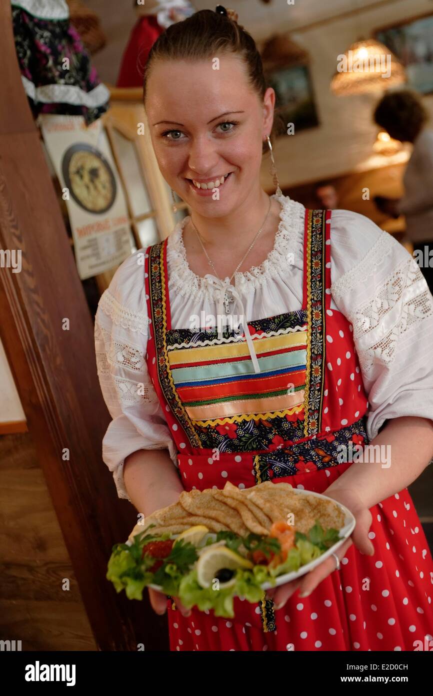 Russia Saint Petersburg listed as World Heritage by UNESCO waitress with a plate of blinis restaurant Blinnij Domik Stock Photo