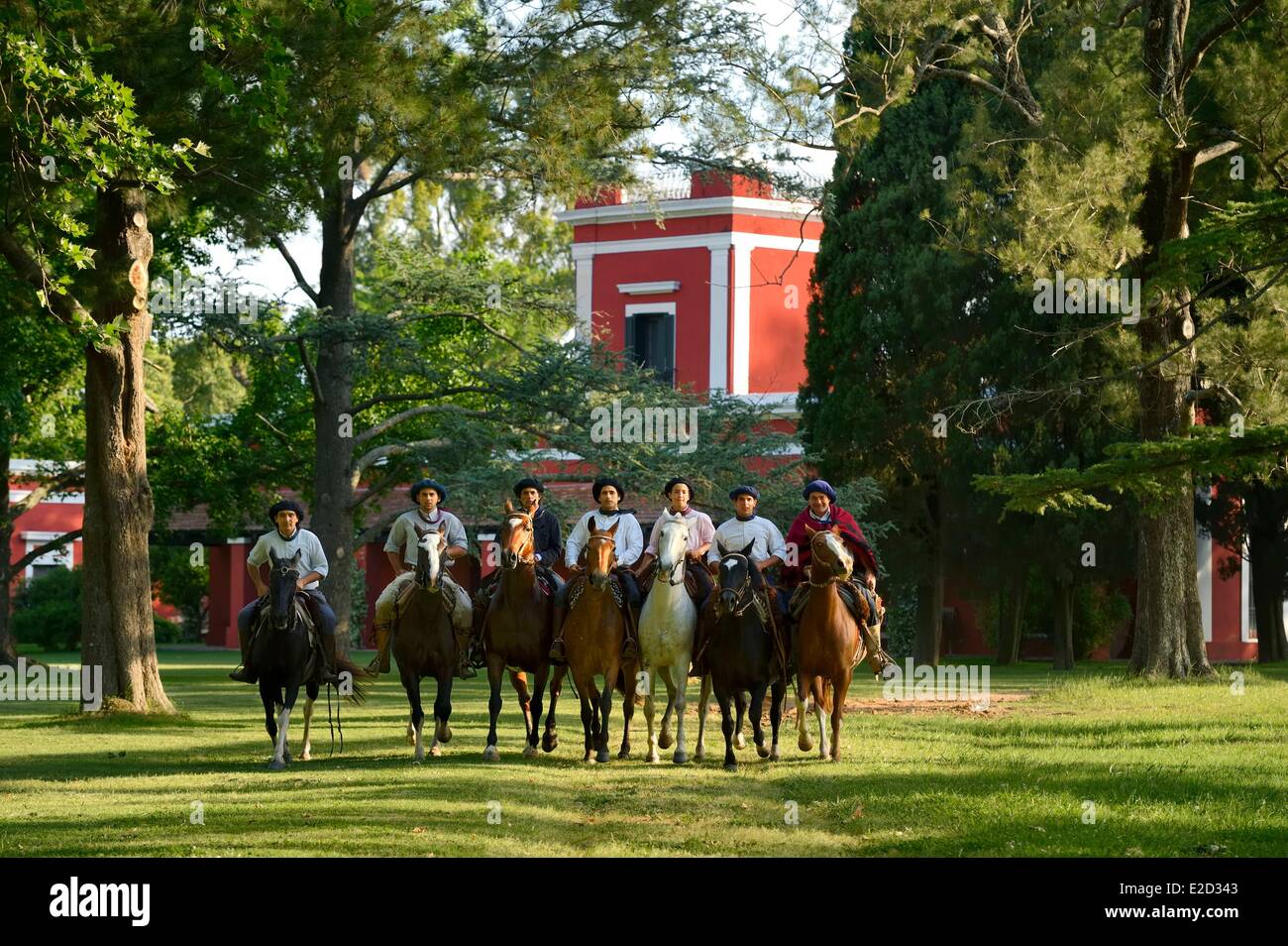 Argentina Buenos Aires Province San Antonio de Areco group of gauchos on horseback in front of the estancia La Bamba de Areco Stock Photo