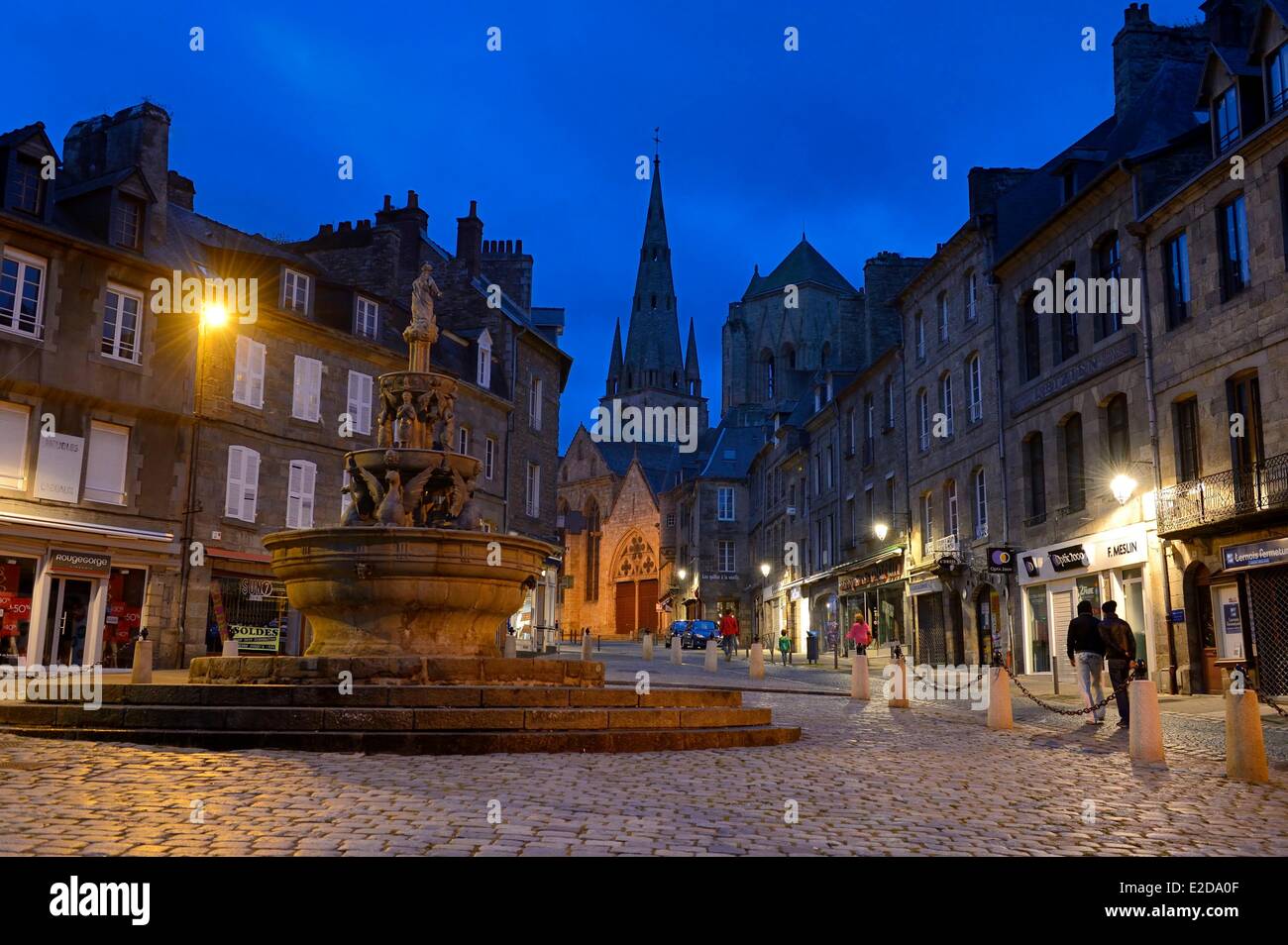 France Cotes d'Armor Guingamp the Plomee Fountain in the place du Centre and the Notre Dame street leading to the Basilica of Stock Photo