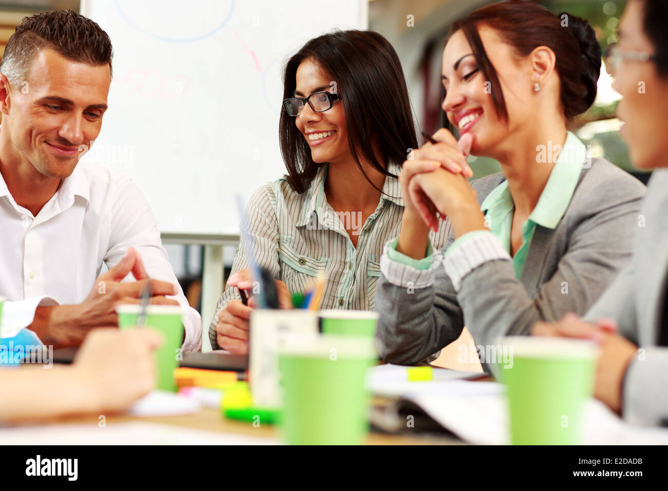 Happy business people sitting around the table at the meeting Stock Photo