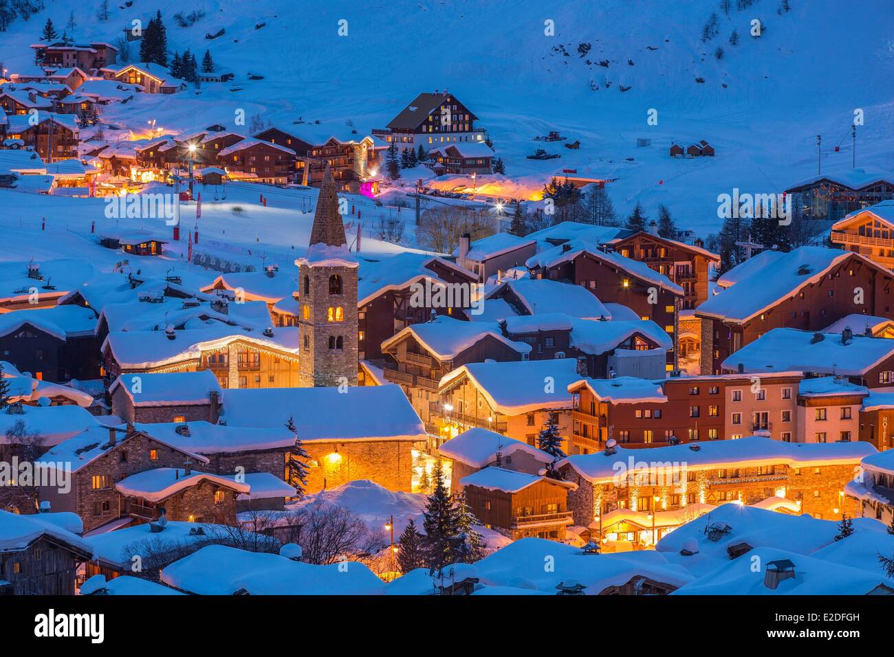 France Savoie Val D'Isere view of the village and Saint Bernard de Menthon Church with a squared Lombard bell tower at dusk Stock Photo