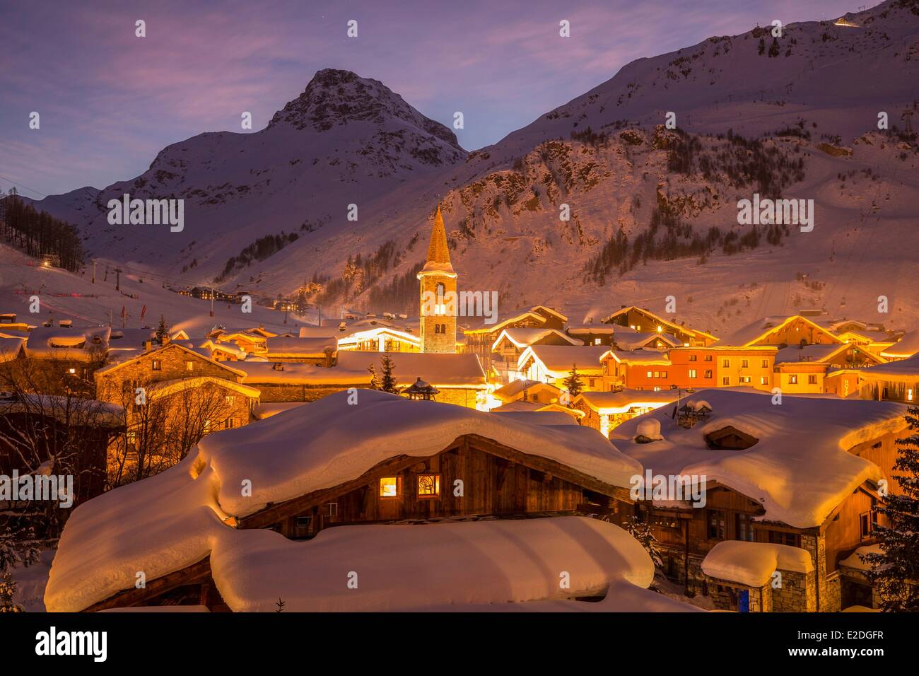 France Savoie Val D'Isere view of the village and Saint Bernard de Menthon Church with a squared Lombard bell tower at dusk and Stock Photo