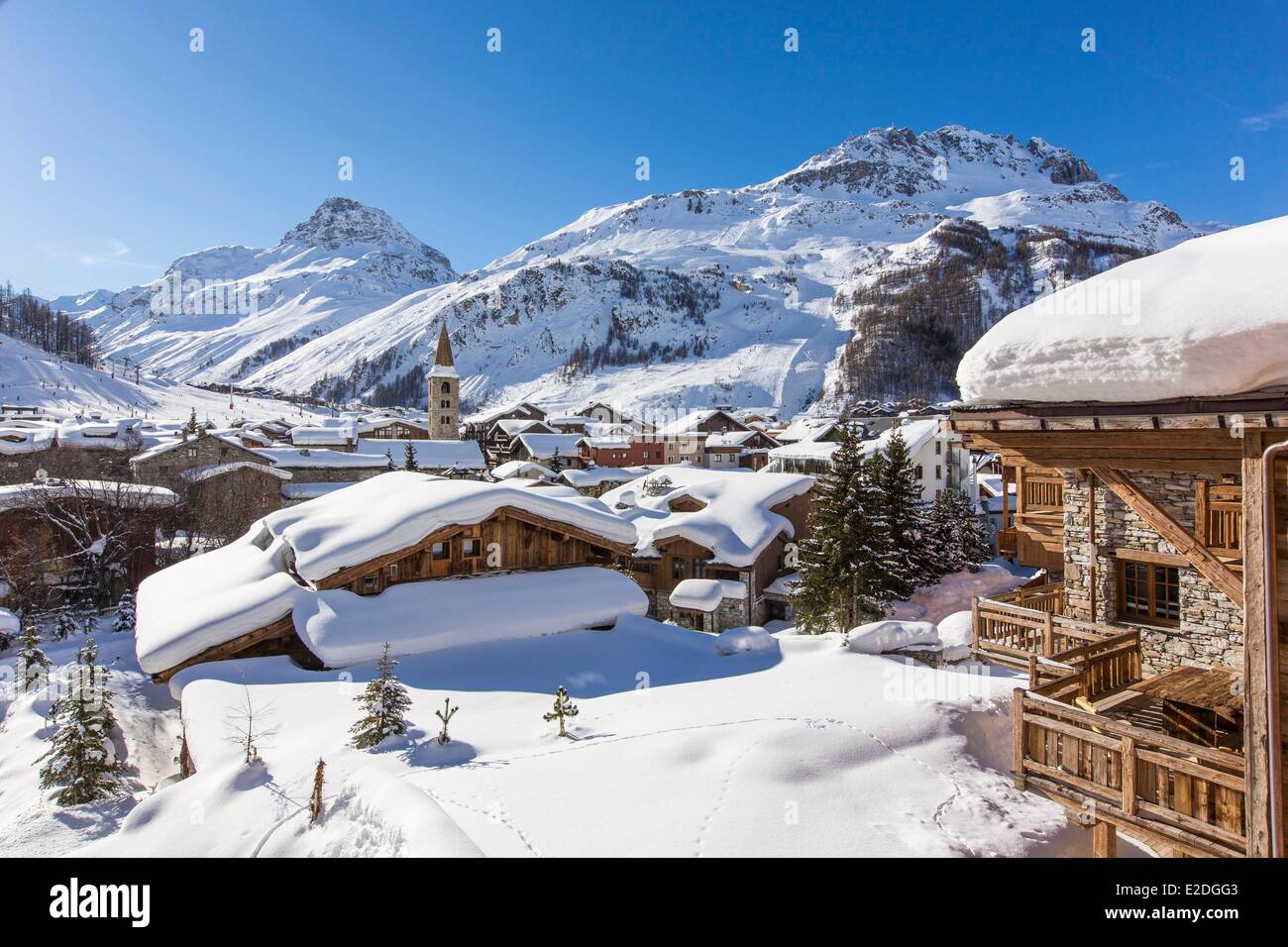 France Savoie Val D'Isere view of the village and Saint Bernard de Menthon Church with a squared Lombard bell tower at dusk and Stock Photo