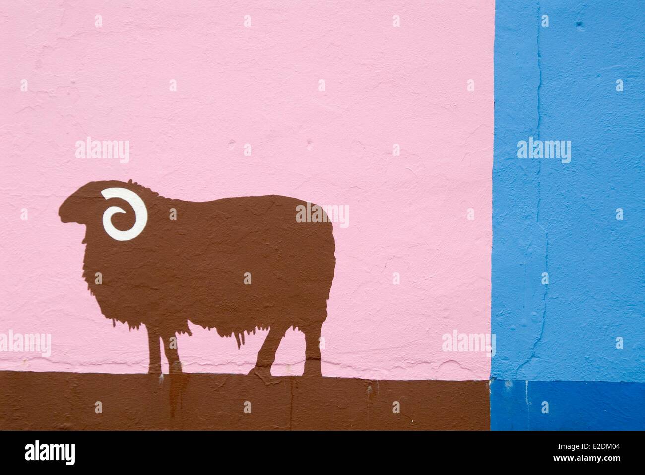 Ireland Galway County Maam Cross Connemara sheep painted in pink and brown on a blue wall Stock Photo
