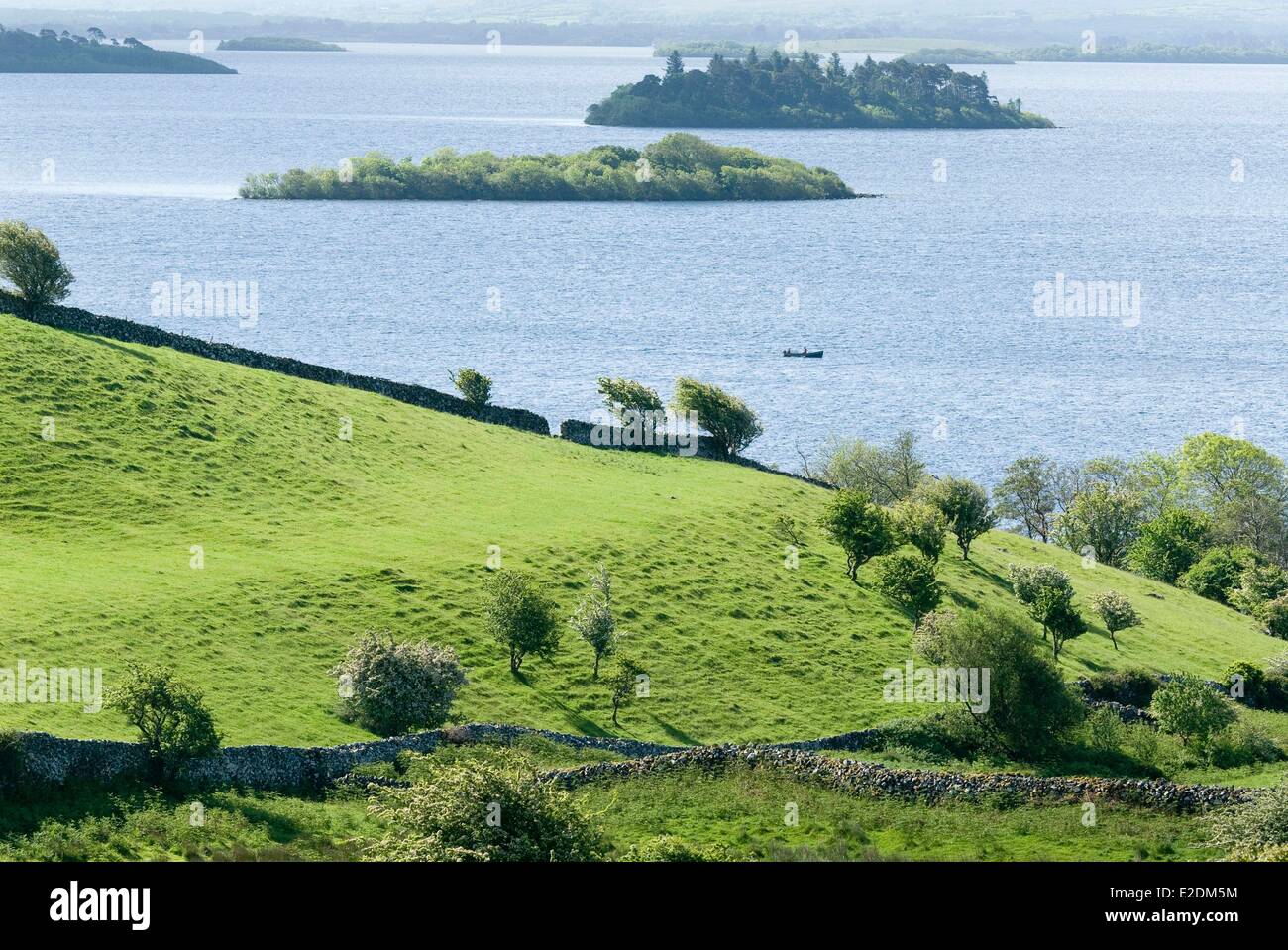 Ireland Galway County Connemara National Park boat on Loch Corrib pastures bounded by dry stone walls Stock Photo