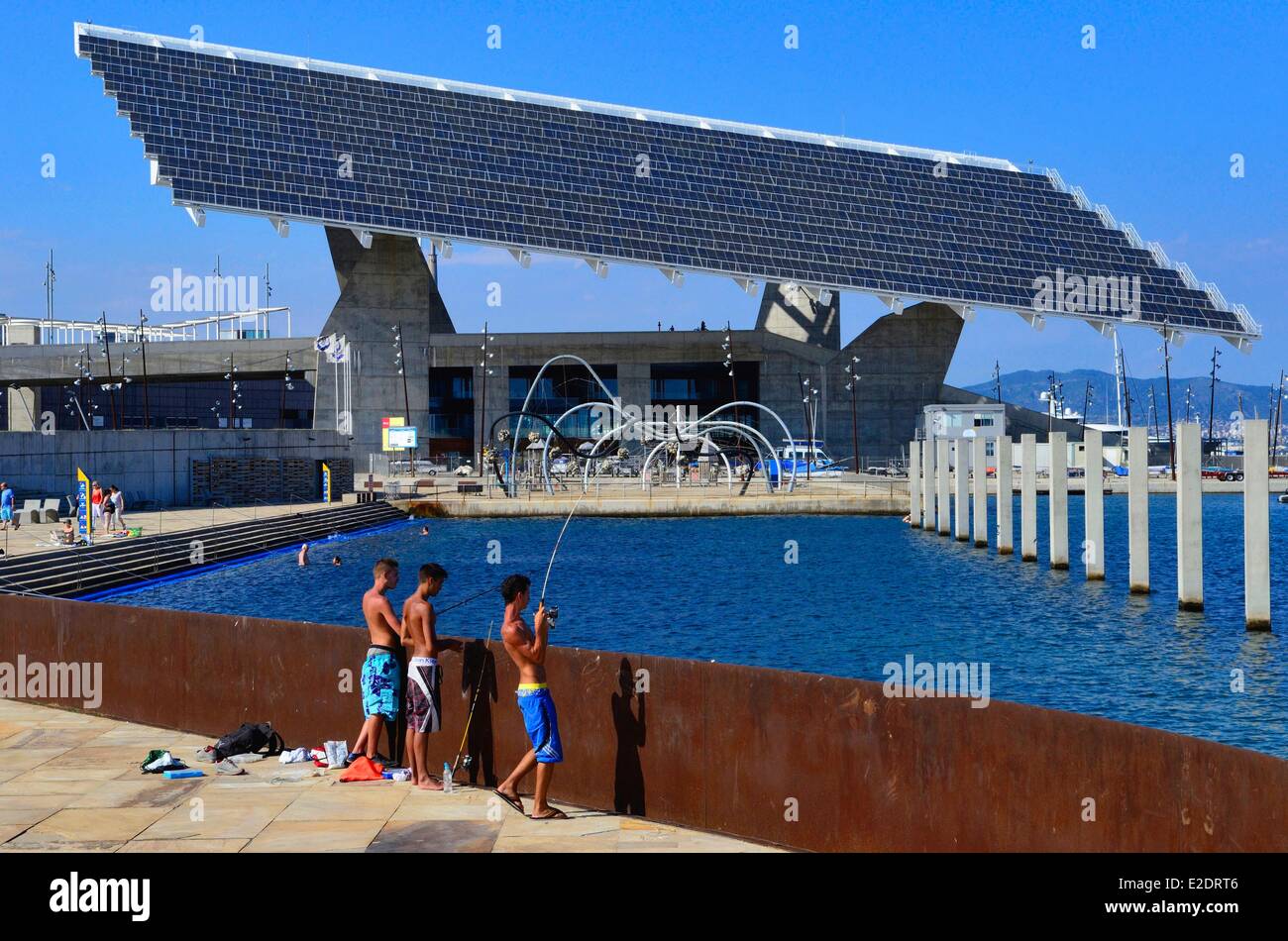 Spain Catalonia Barcelona the Forum park young fishermen near the pergola fotovoltaica giant solar panel designed by the Stock Photo