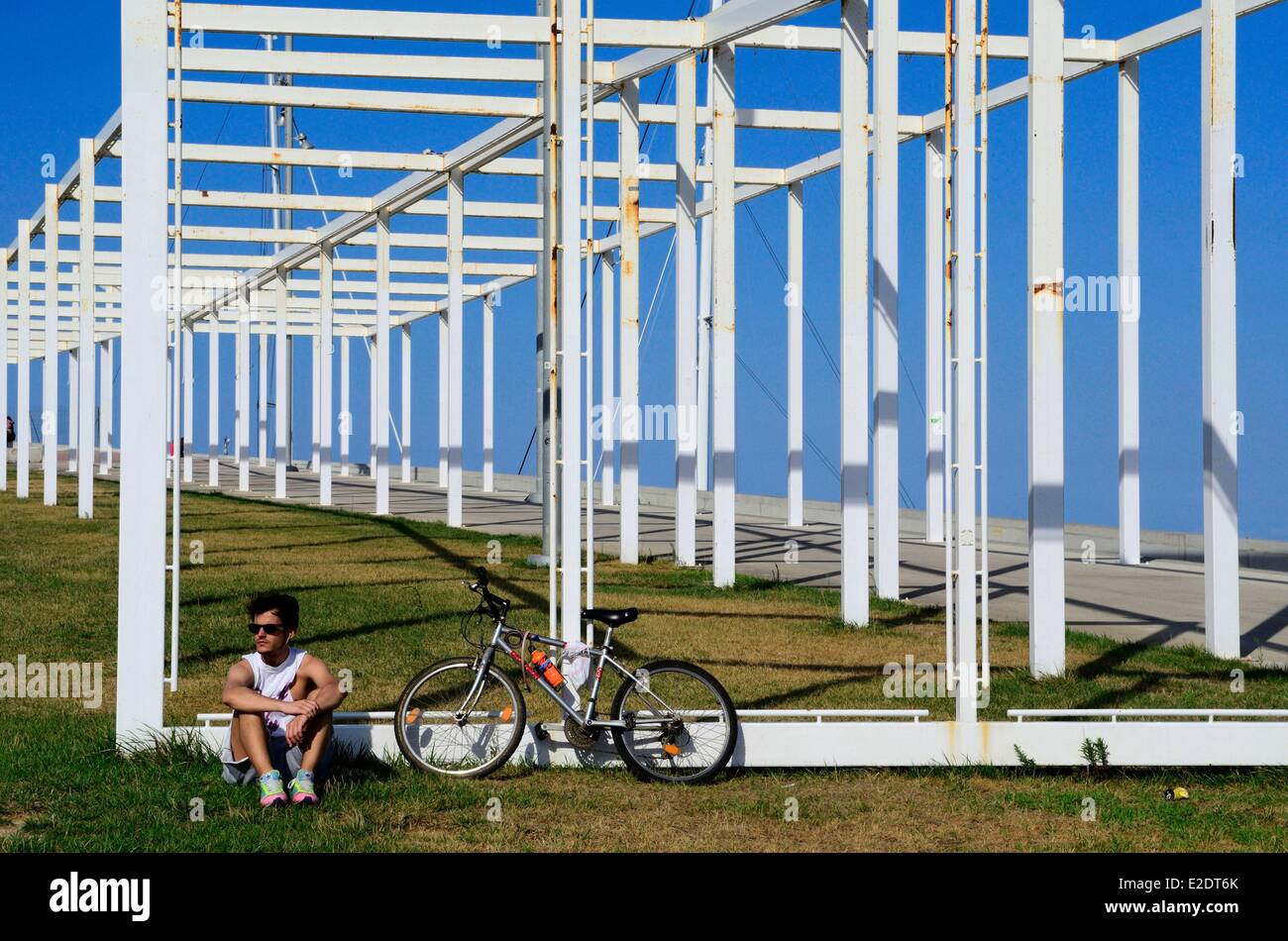 Spain Catalonia Barcelona the Forum park a cyclist near the pergola fotovoltaica giant solar panel designed by the architects Stock Photo