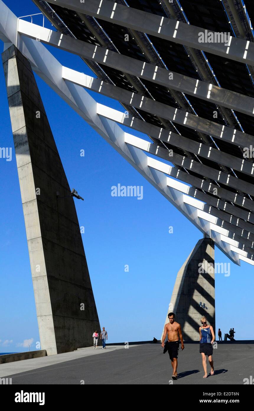 Spain Catalonia Barcelona the Forum park walkers near the pergola fotovoltaica giant solar panel designed by the architects Stock Photo
