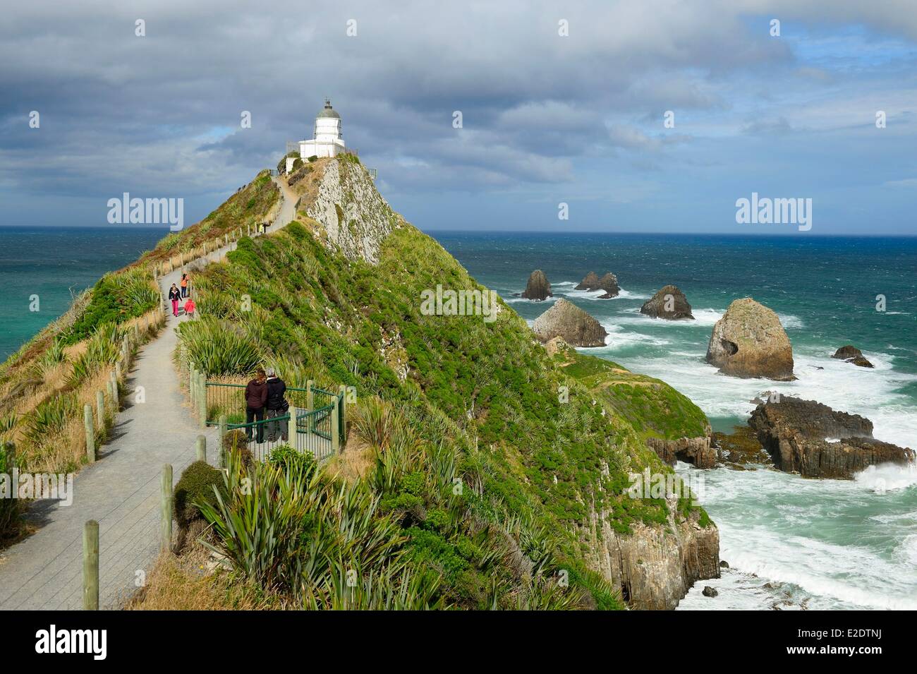 New Zealand South island the Catlins off the beaten trails along the south coast rocky outcrop at Nugget Point Lighthouse with Stock Photo