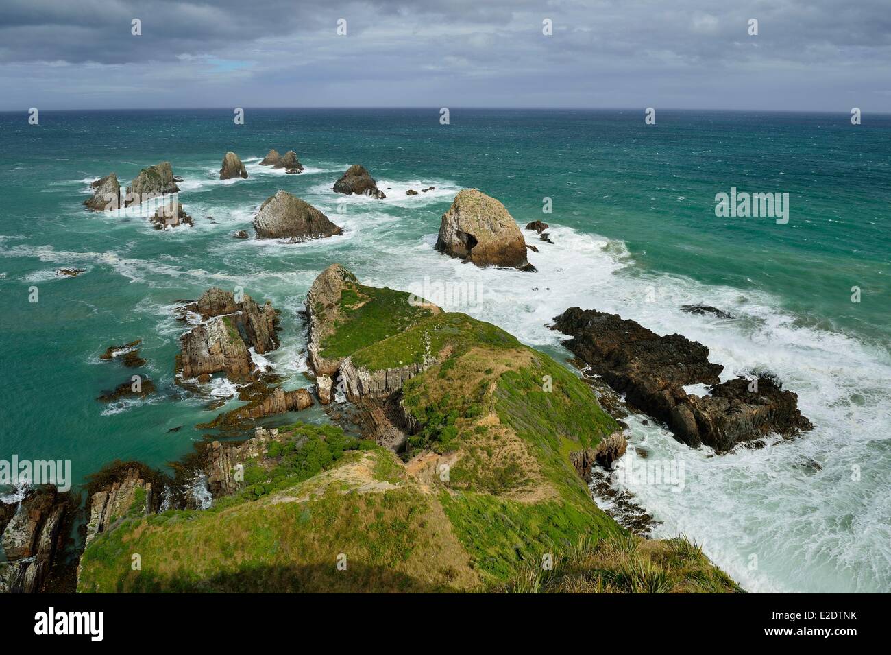 New Zealand South island the Catlins off the beaten trails along the south coast rocky outcrop at Nugget Point Lighthouse with Stock Photo