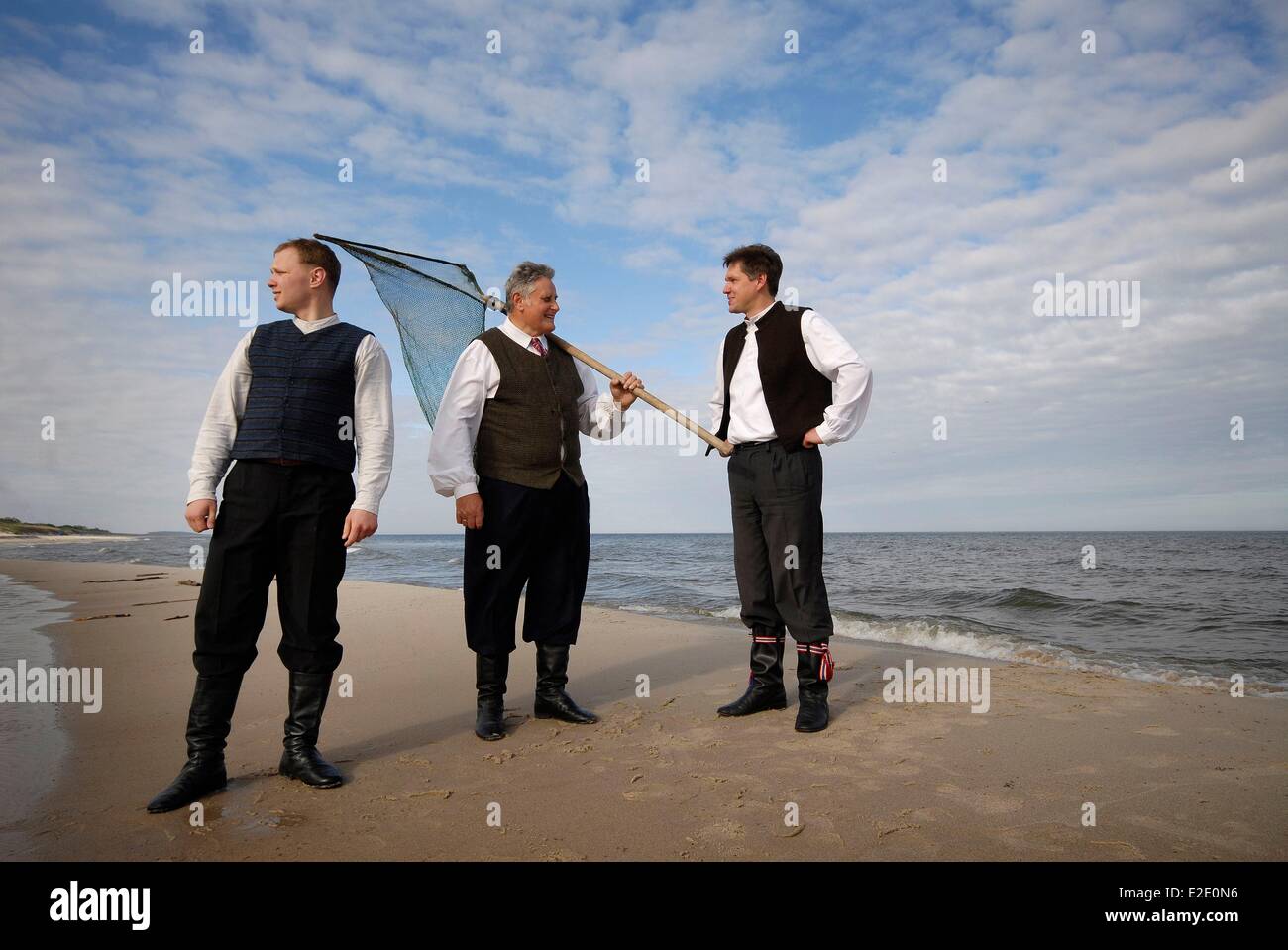 Lithuania County Neringa Nida three men wearing the traditional Lithuanian suit on the beach Stock Photo