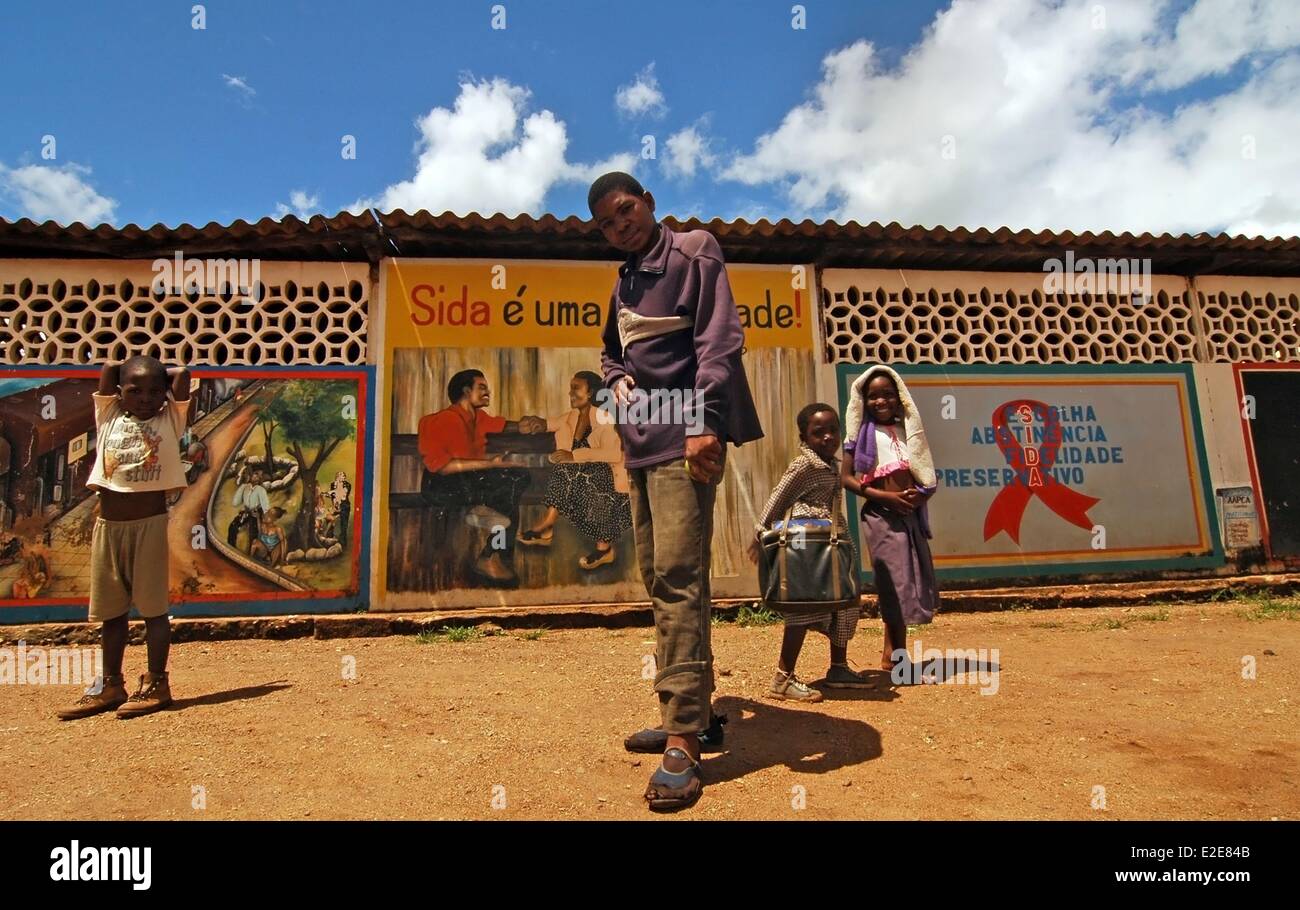 Mozambique, Cuamba, portrait of a young man with children standing in ...