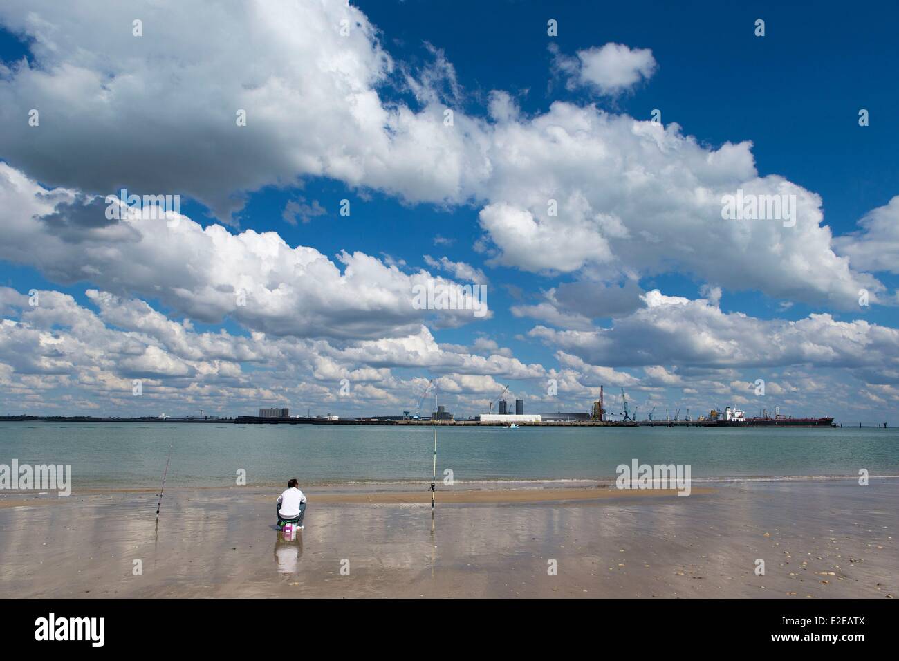 France, Charente Maritime, Ile de Re, Rivedoux Plage, fisherman on the beach facing the Grand Port Maritime de La Rochelle (La Rochelle commercial deep water port) Stock Photo