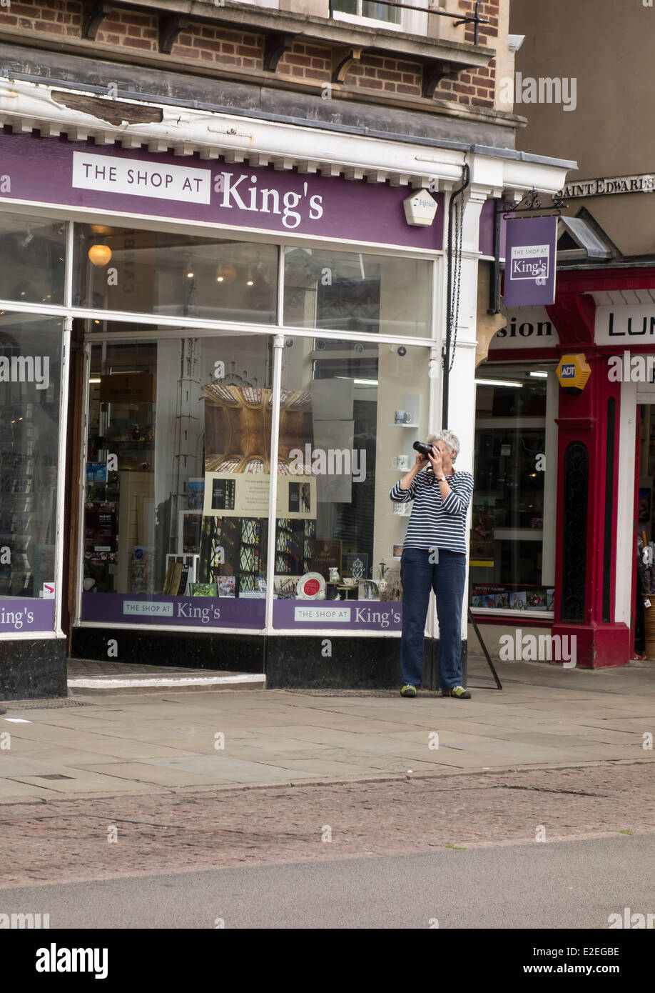 Photographer taking photographs in Kings Parade Cambridge England Stock Photo