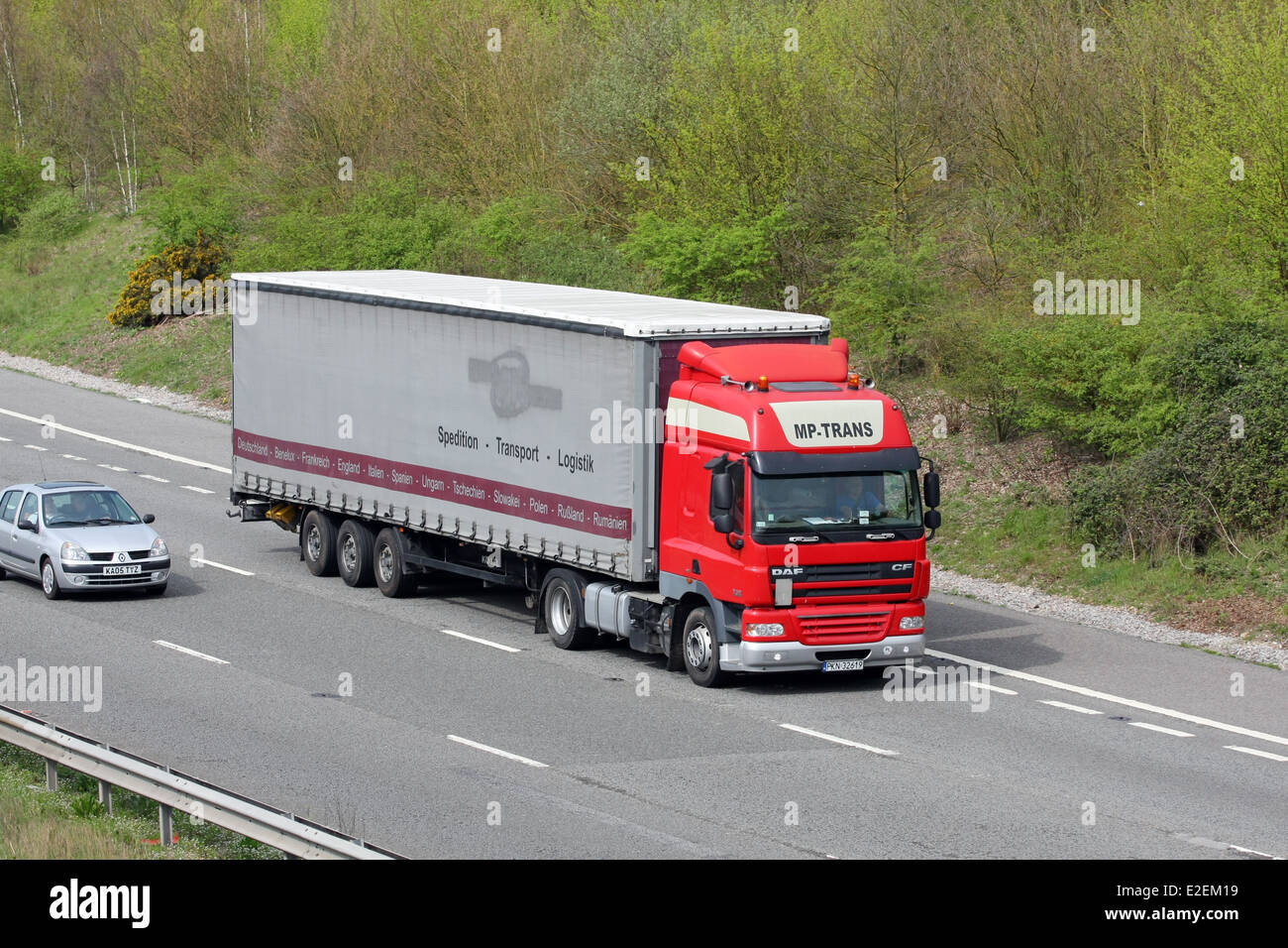 A foreign truck and a car traveling along the M20 motorway in Kent, England Stock Photo