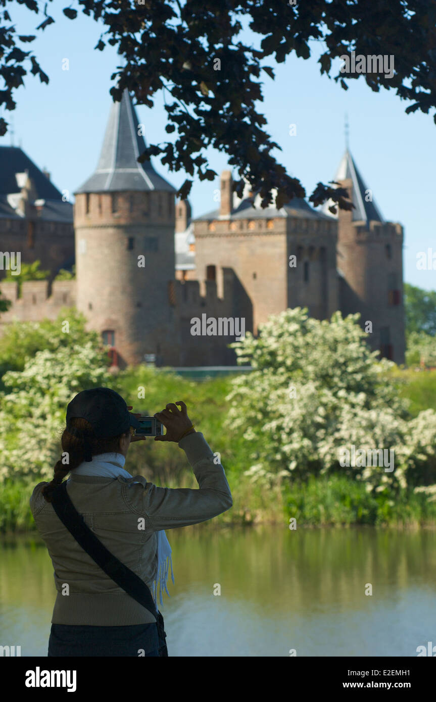 Woman photographing the Muiderslot castle in Muiden, The Netherlands Stock Photo
