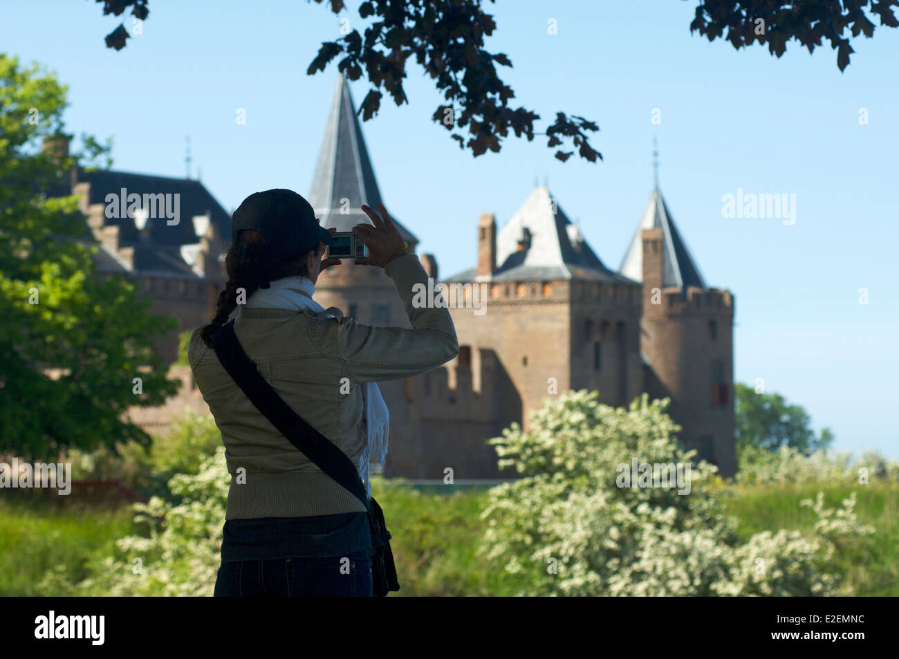 Woman photographing the Muiderslot castle in Muiden, The Netherlands Stock Photo