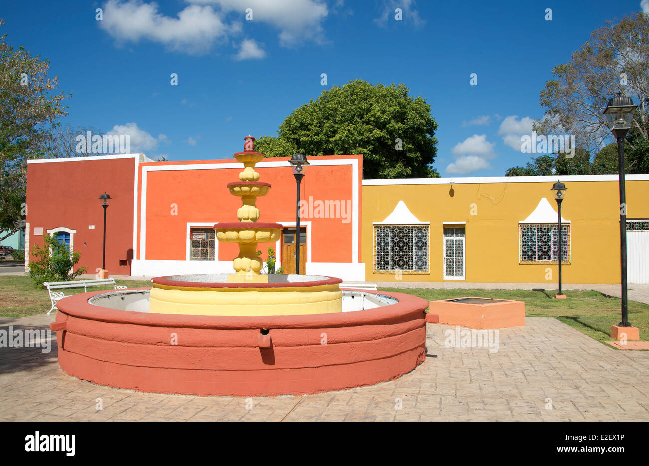 Fountain and colourful restored painted houses Valladolid Yucatan Mexico Stock Photo