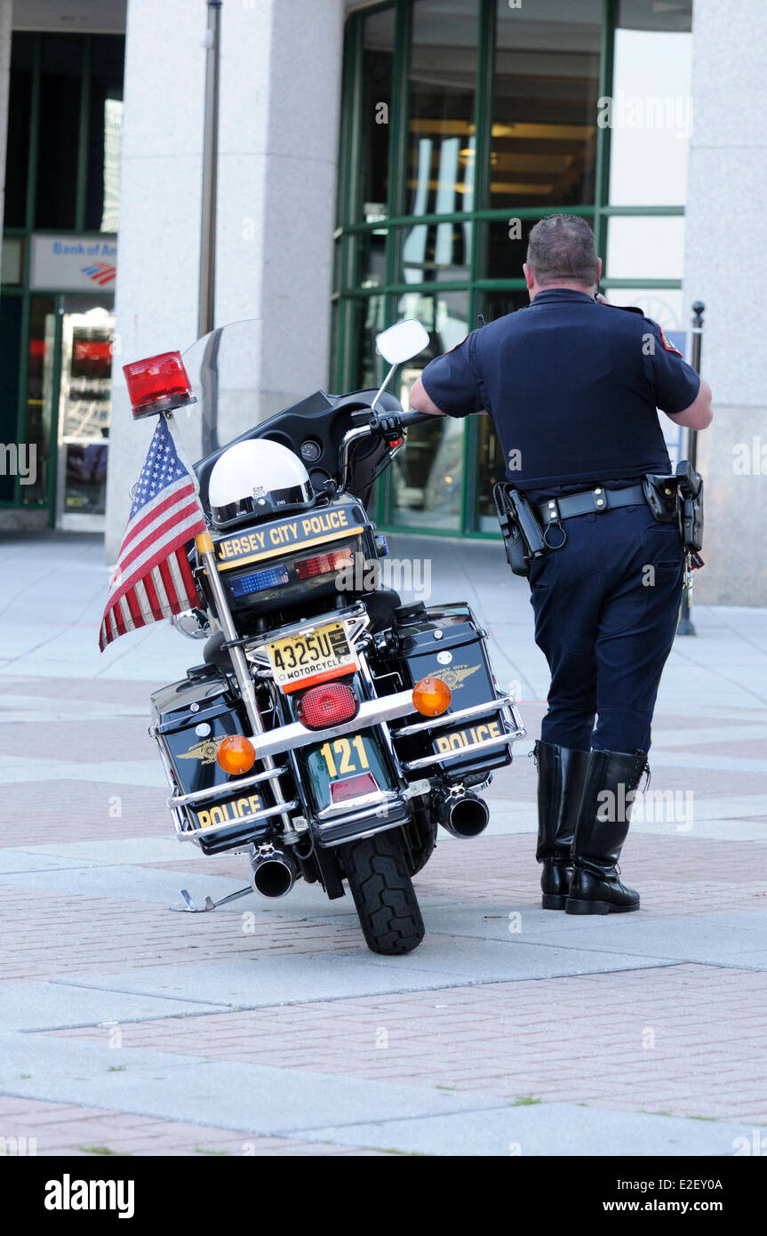 United States, New Jersey, Jersey City, Exchange Place, motorcycle and policeman viewed from behind Stock Photo