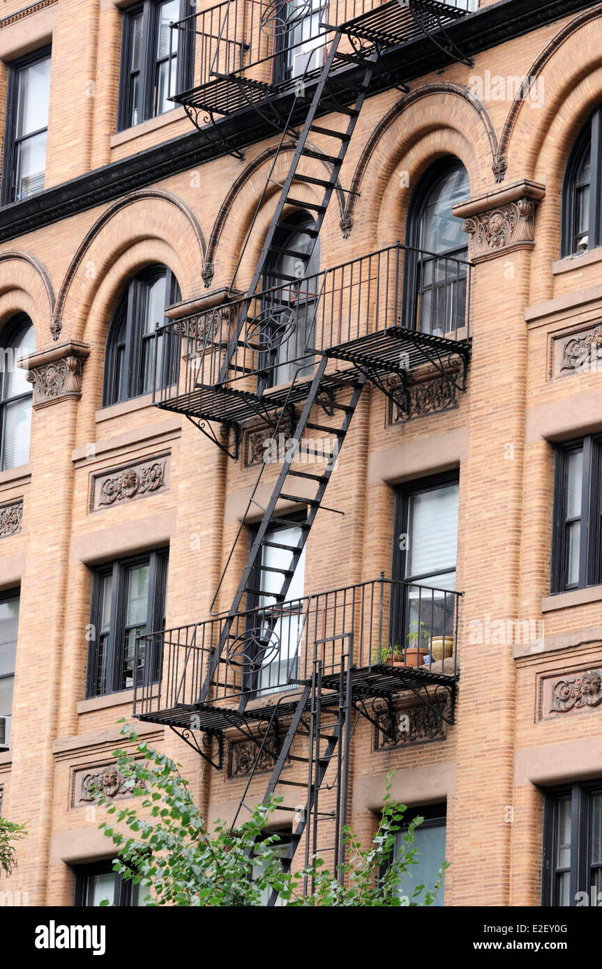 United States, New York, Columbus Avenue, ocher facade of a building with its emergency stairs Stock Photo