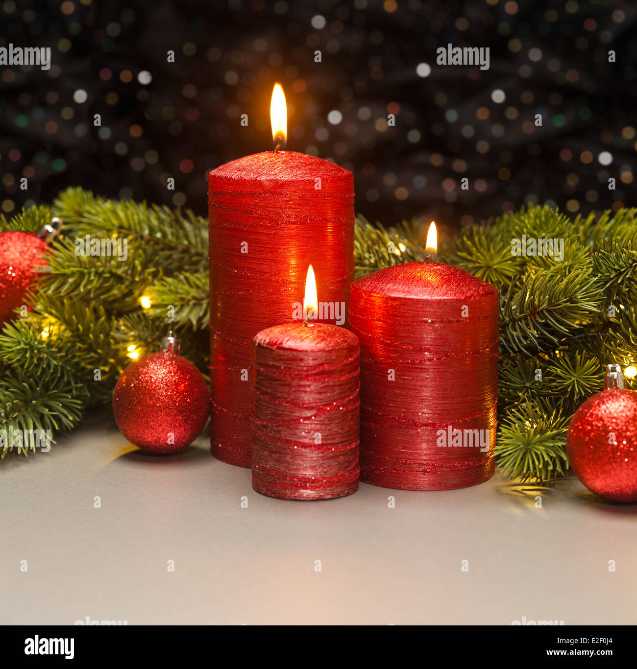Three red Candles with Christmas tree branches decorated Stock Photo