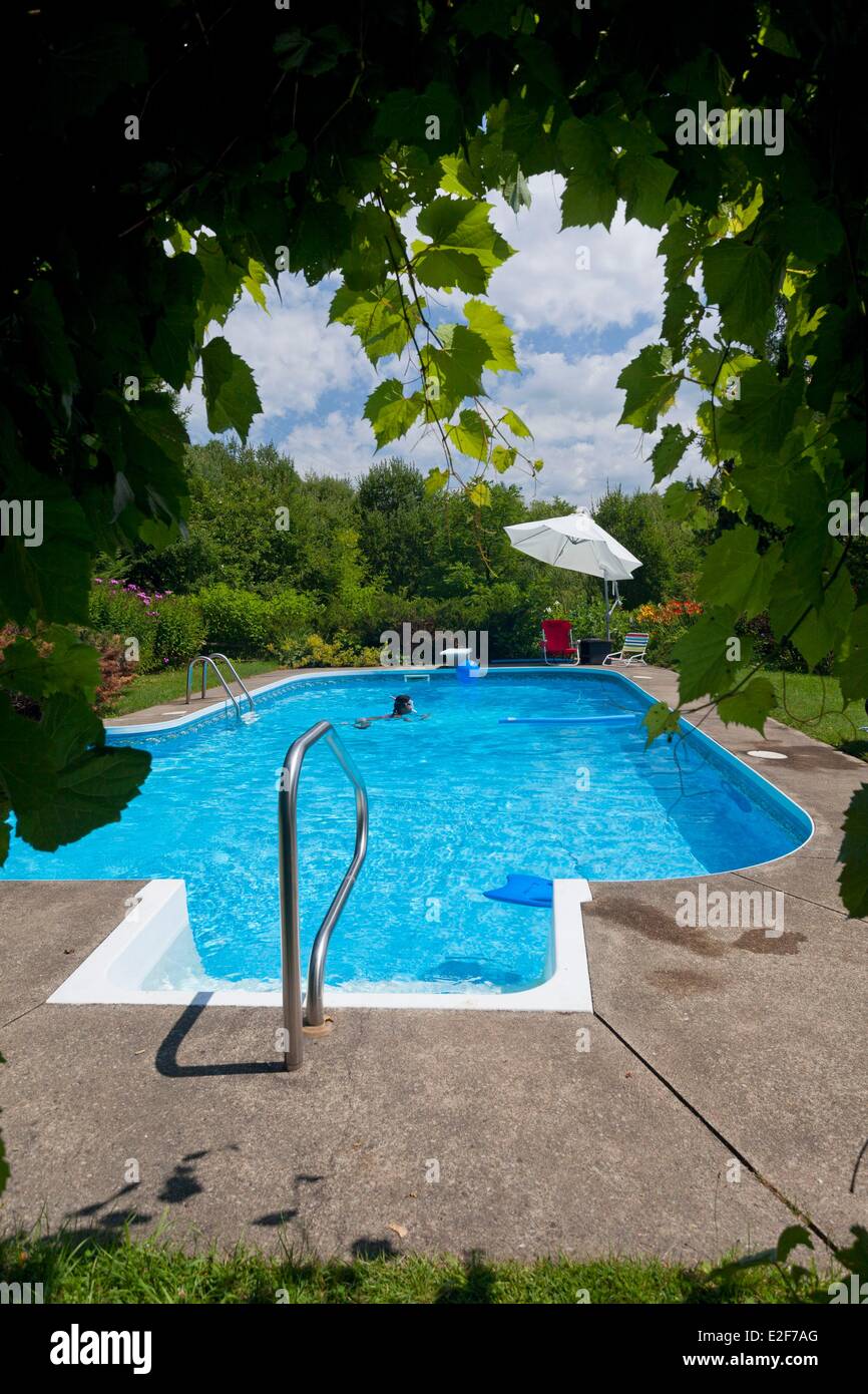 Canada, Quebec, the Eastern Townships or Estrie, private pool and young swimmer Stock Photo