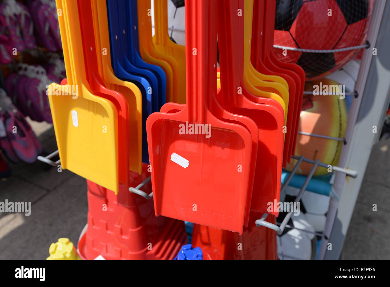 Colorful plastic spades for sale on the beach Stock Photo