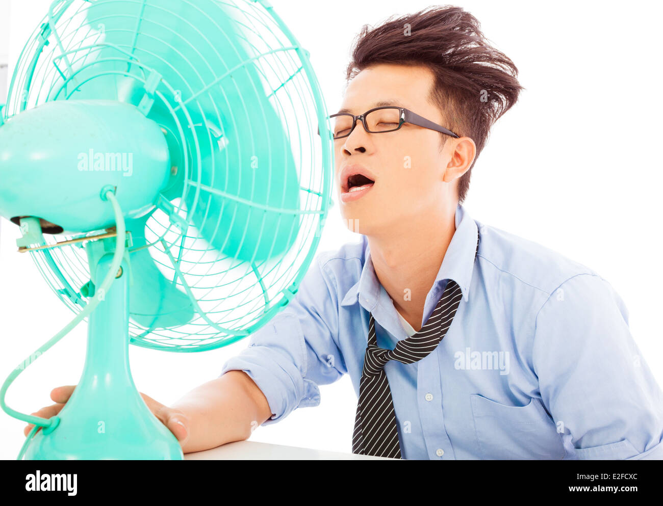 young business man use fans to cool down Stock Photo