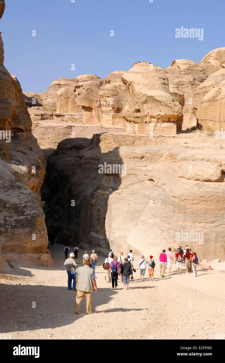 Jordan Ma'an Governorate Wadi Musa Petra the Siq or Ditch long narrow and  winding passage and its aqueduct tourists walking to Stock Photo - Alamy