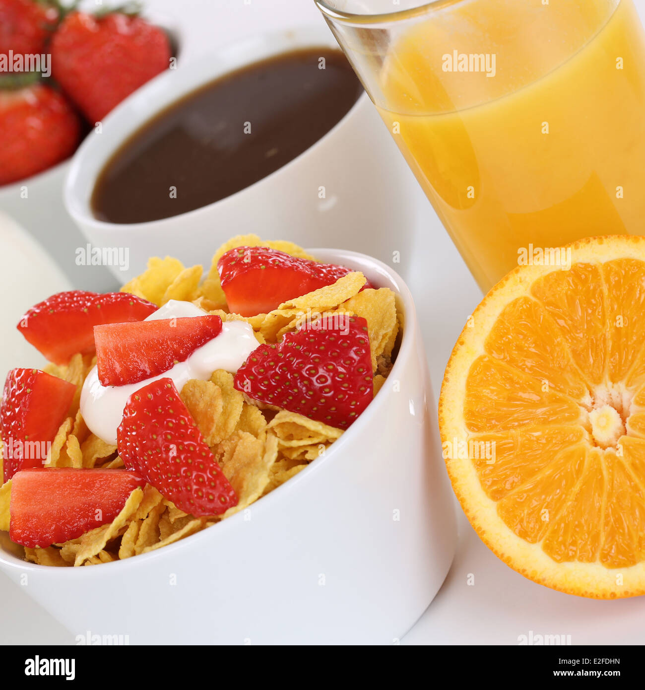 Breakfast with fruit cereals, orange juice, coffee and milk Stock Photo
