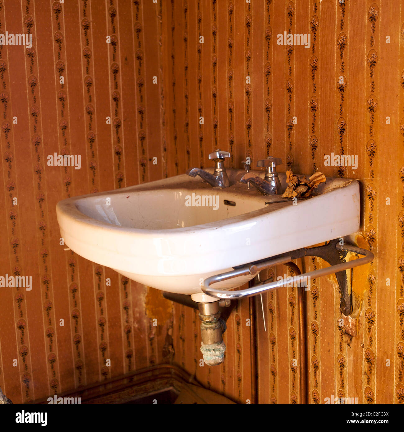 Old-fashioned washbasin in a house set for renovation Stock Photo