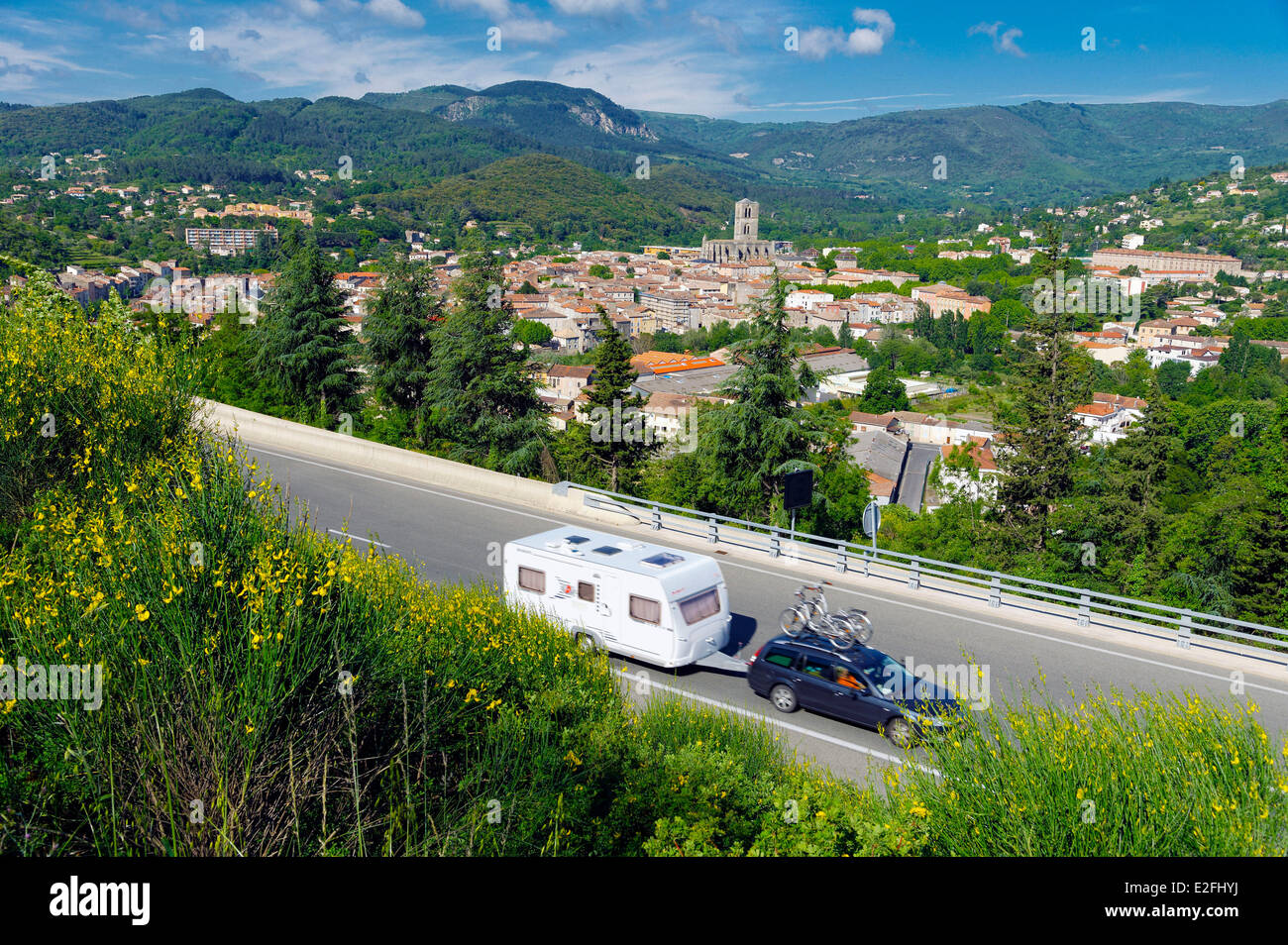 France Herault  Lodeve caravan hitched in a car on the highway The Meridian line with the cathedral Saint Fulcran of the 13th Stock Photo