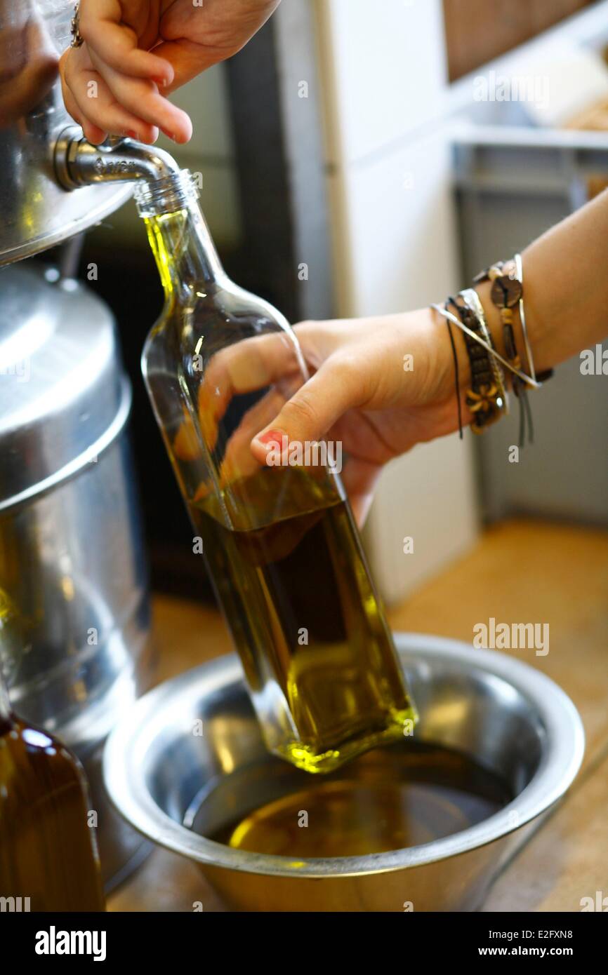 France Ardeche Payzac filling a olive oil bottle at a olive oil producer place Stock Photo