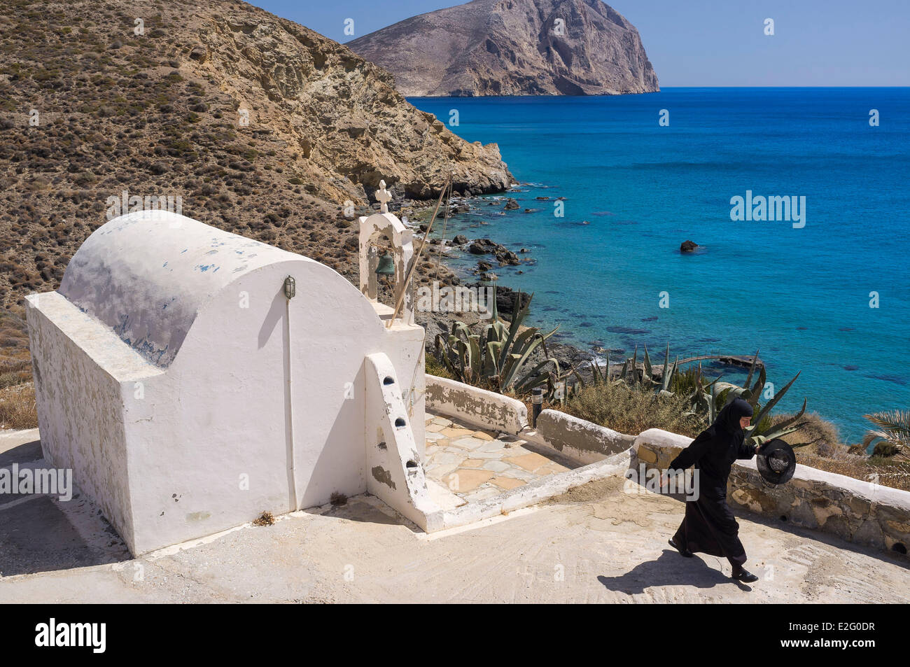 Greece Cyclades Islands Anafi Island chapel along the coastal footpath and Kalamos rock in the background Stock Photo