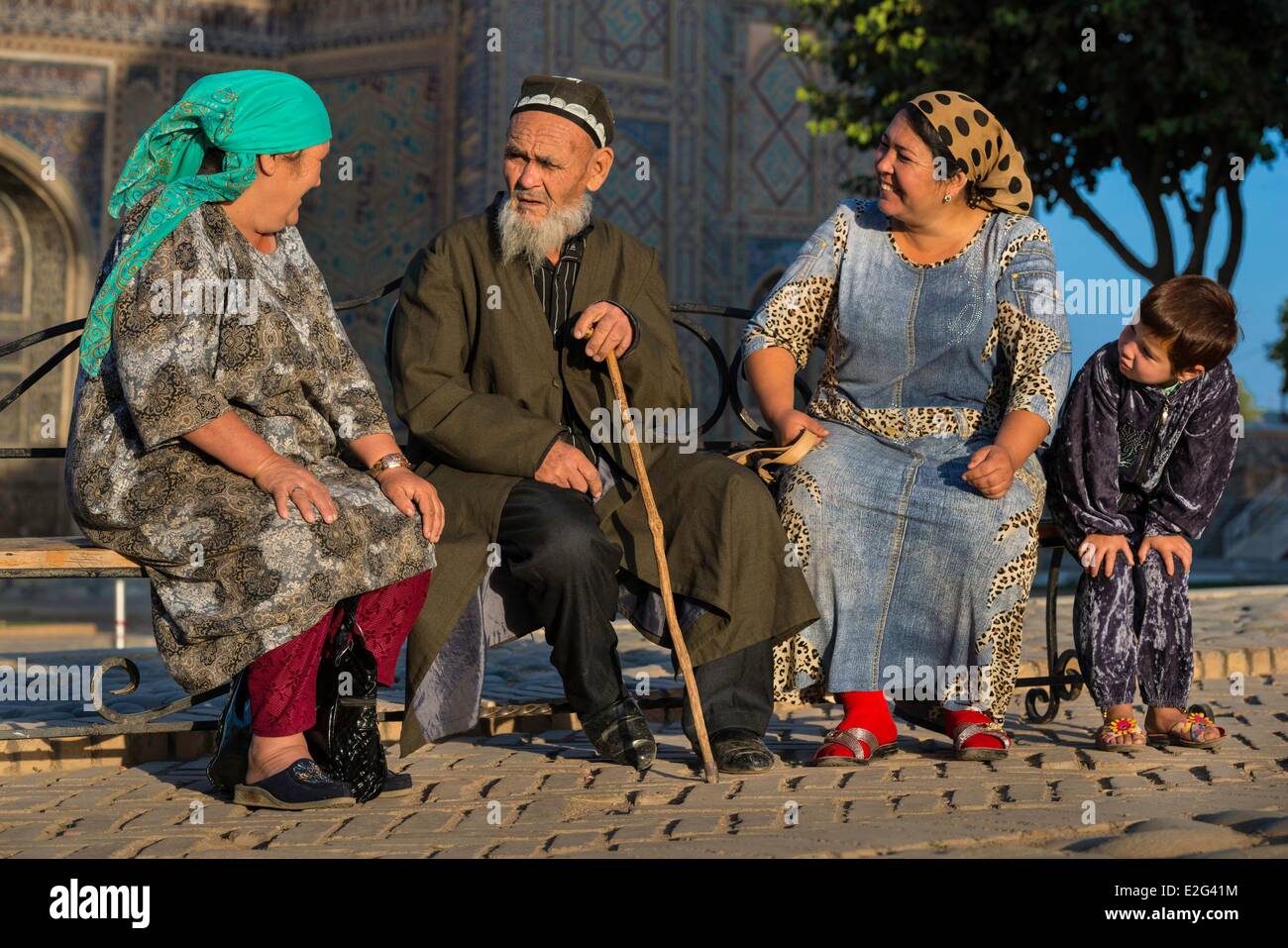 Uzbekistan Silk Road Samarkand listed as World Heritage by UNESCO Registan place Ferghana valley pilgrims in front of the Ulugh Stock Photo