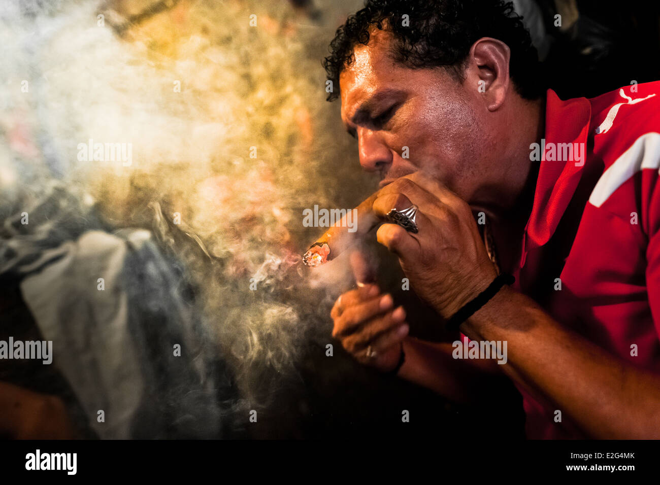 A Salvadorean 'brujo' (sorcerer) predicts the future from burn tobacco  leaves in a street fortune telling shop in San Salvador Stock Photo