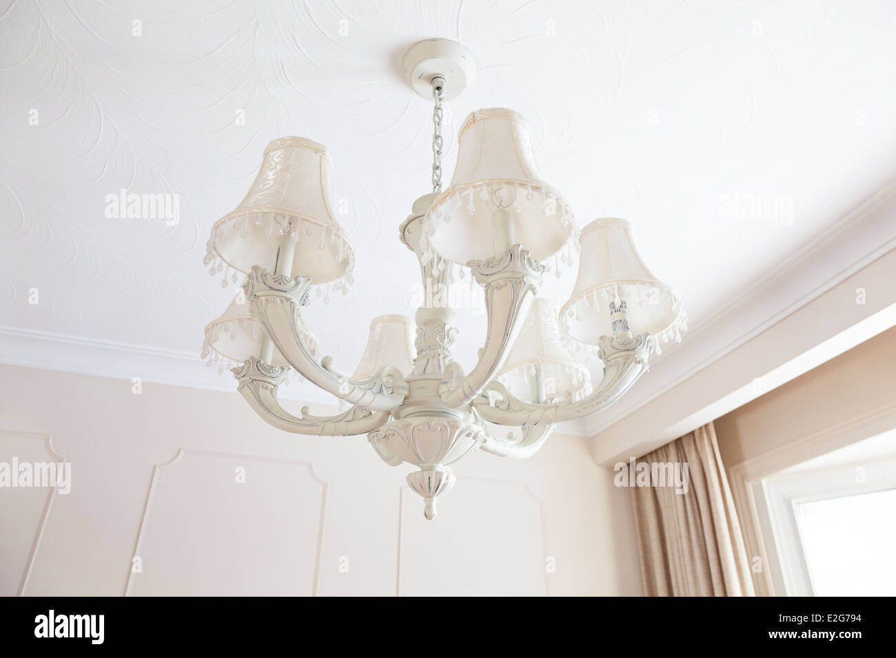 A chandelier hanging from a ceiling in a brightly lit room. Ontario, Canada. Stock Photo