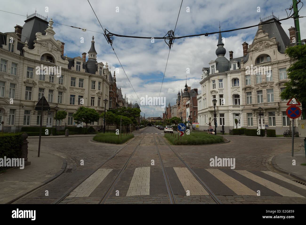 A photograph of a street scene with tram lines in Antwerp, Belgium. The Zurenborg neighborhood is a little off the beaten track. Stock Photo