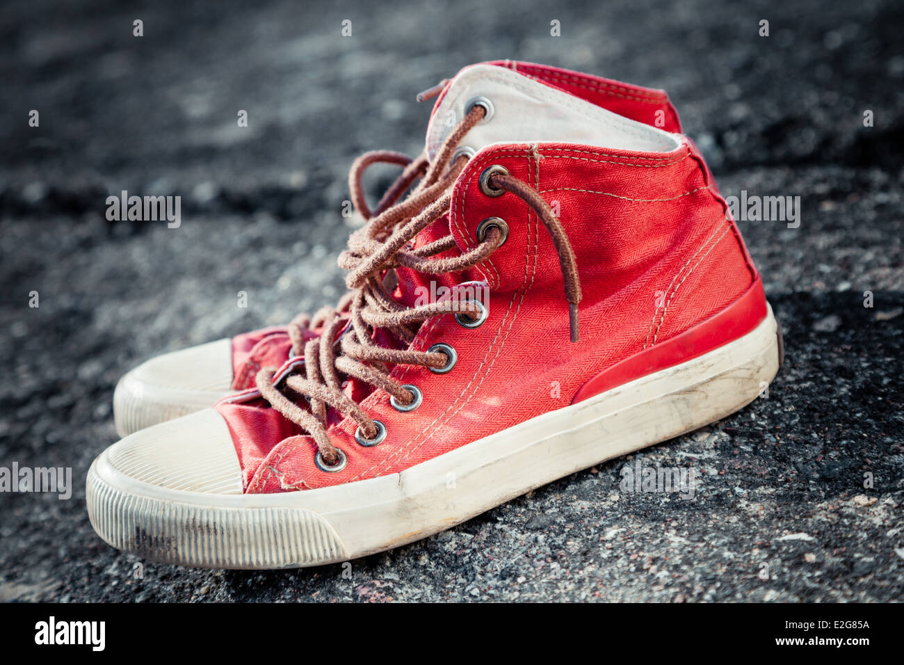red sneakers on asphalt road Stock Photo